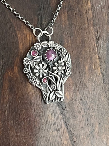Hieronymus Bosch inspired skull.  With flowers and rubies. Sterling silver handmade.