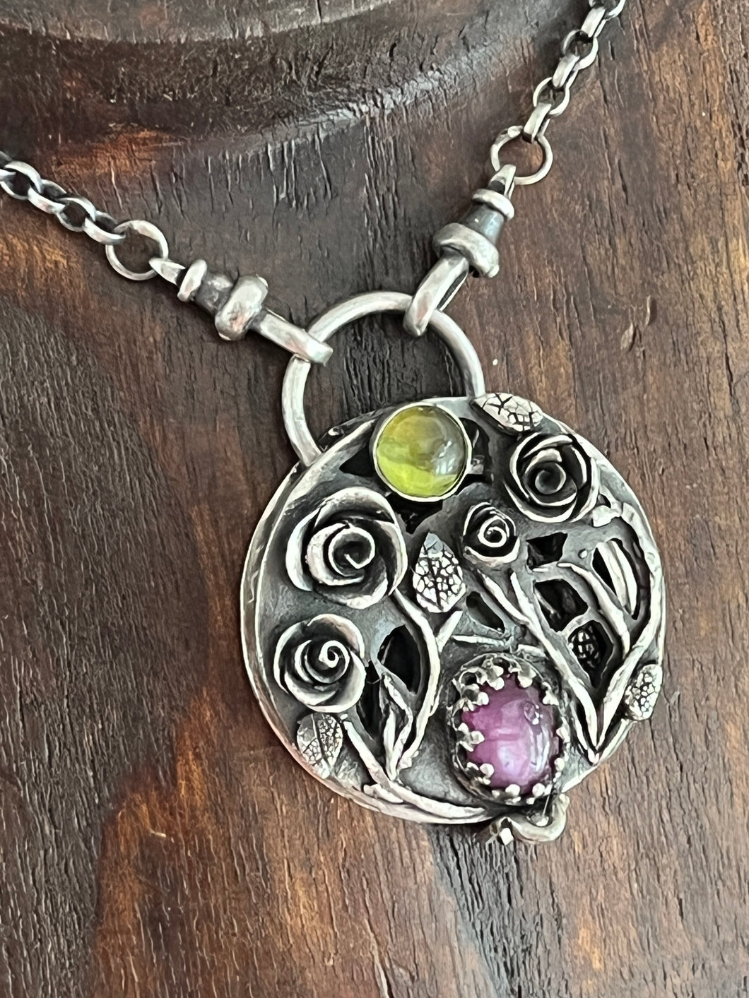 Duality locket, today we bloom, tomorrow we die.  Sterling silver with ruby and vesuvianite.