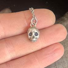Load image into Gallery viewer, Sterling silver skull with 2 blue sapphire eyes.