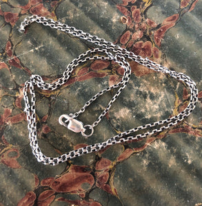 Simple light 1.4mm sterling silver rolo chain.   You choose the length.