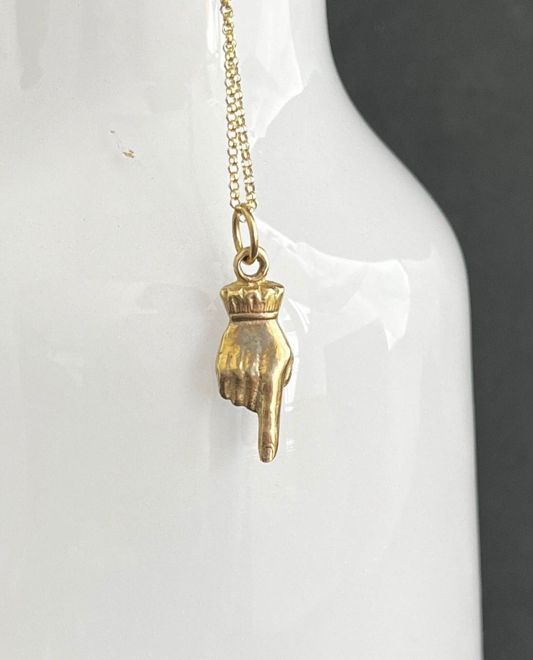 Gold best sale fist pendant