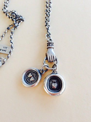 Antique wax letter seal necklace, with heart charms, on a long sterling rolo chain, with a hand holder.