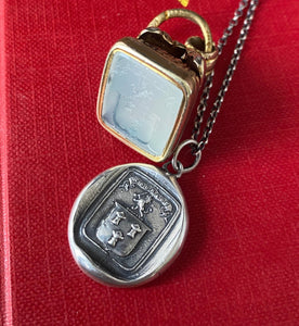 Courage, have to courage to succeed. Reap your rewards.  success. Lion and weath sheafs heraldry pendant. Antique wax seal impression.